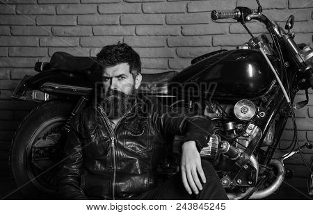 Hipster, Brutal Biker On Pensive Face In Leather Jacket Sits, Leans On Motorcycle. Bikers Lifestyle 