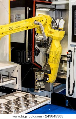 Moscow, Russia - May, 2018: Fanuc M-20ia Robot Hand With Schunk Gripper Operating With Cnc Machine