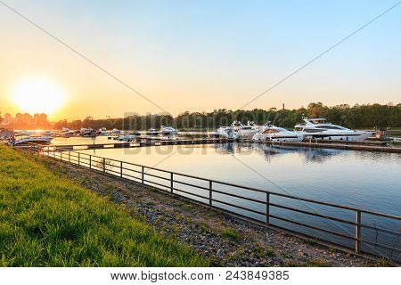 Luxury Yachts Docked In Marina At Colorful Sunset. Modern Motor Boats Parking At Pier. Summer View O