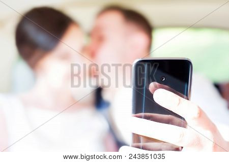 Just Married Happy Kissing Wedding Couple Sitting In The Car Together Doing Self Portrait With Moder