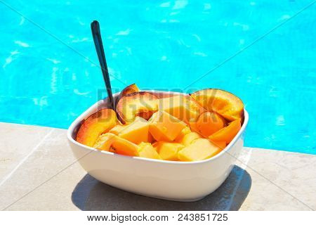 Fruit In A Bowl By The Pool. Fruit Salad, Healthy Breakfast. Colorful Fruit Peach And Melon, Summer 