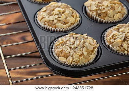 Homemade Blueberry Bran Muffins With Almond In Bakeware On Broun Wooden Background