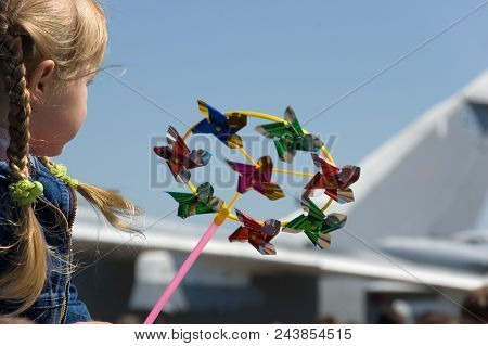 Child With Toy Looking At Military Airplane