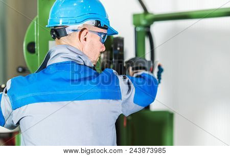 Professional Heavy Duty Machinery Operator. Caucasian Metalworking Industry Worker In Blue Hard Hat 