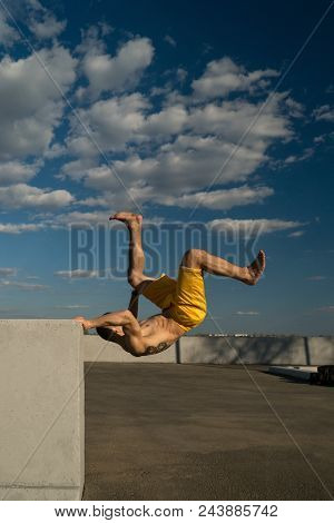 Tricking On Street. Martial Arts And Parkour Elements. Man Flips Back Barefoot. Taken From Low Angle