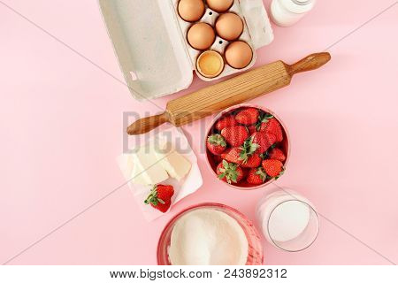 Raw Ingredients For Cooking Strawberry Pie On Pink Background  (eggs, Flour, Milk, Sugar, Strawberry