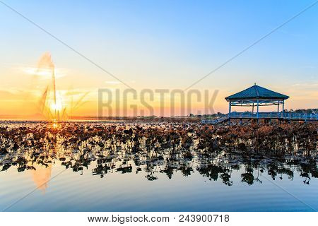 Sunset With Water Fountain At The Pavilion On Lake Or Pond Or Swamp Of Bueng See Fai, Phichit, Thail
