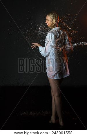 Nice Girl In The White Shirt And Water Drops Behind And Arround Her Illuminated By Light During A Ph