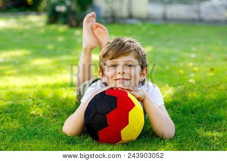 Happy Active Kid Boy Playing Soccer With Ball In German Flag Colors. Healthy Child Having Fun With F
