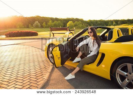 Obsessed With The Cars! Attractive Serious Perfect Gorgeous Young Girl, While Wearing Glasses, Sitti