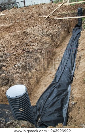 View Of Drainage Pipes And Inspection Well For Removal Of Water From A Site Under Construction Of Th
