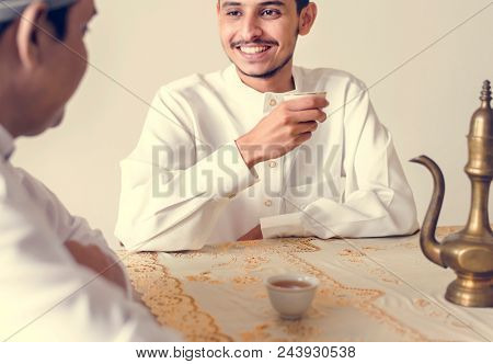 Muslim men having a cup of tea