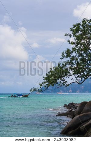 Beautiful Sea With The Tree And Rocks With The Sailing Boats Behind