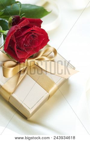 Valentine Gift Gold And Red Rose On White Background.