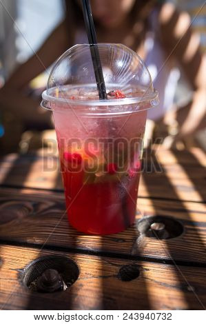 Refreshing Cocktail On A Wooden Table With Sunglasses