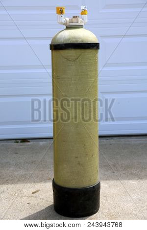 Deionized water filter. Pure Water Filter outside in a driveway. Deionized water is used for industrial and commercial uses including window washing and pharmaceutical mfg.