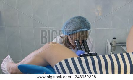 Gynecologist Examining Female Patient Using Colposcope. Close Up Shot. Professional