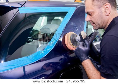 A Man Is Polishing A Blue Car. Polishing Machine And Polishing Paste For Gloss.