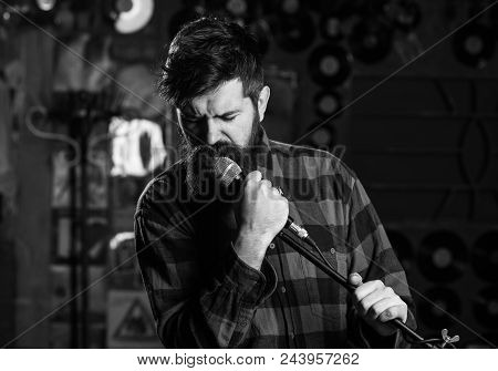 Music And Leisure Concept. Man With Enthusiastic Face Holds Microphone, Singing Song, Karaoke Club B