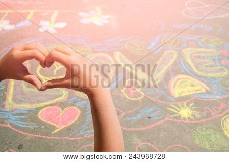 The Inscription In Multi-colored Chalk On Asphalt In English Love