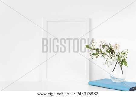 White Frame Mock Up With Spring Cherry Bouquet And Blue Notebook. Mock Up For Your Photo, Design Or 