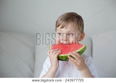 A Small Cute Boy 4 Years Old Is Eating A Watermelon. Summer. Heat. Watermelon. Portrait Of A Happy B