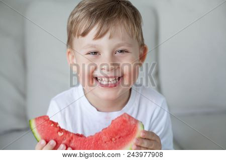 A Small Cute Boy 4 Years Old Is Eating A Watermelon. Summer. Heat. Watermelon. Portrait Of A Happy B