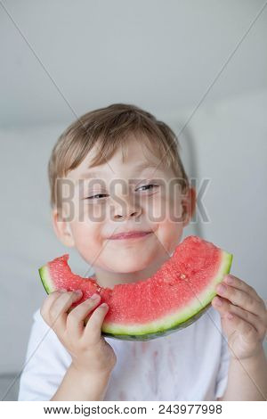 A Small Cute Boy 4 Years Old Is Eating A Watermelon. Summer. Heat. Watermelon. Portrait Of A Happy B
