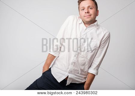 Caucasian Shy Man Hiding Hands In Pockets. He Is Feeling Shy Or Sorry For What He Did