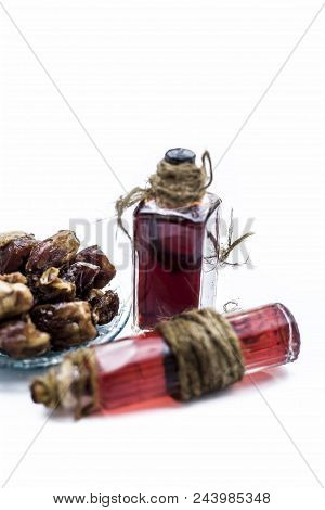 Sweet And Floral Essence Of Date Or Khajoor In Bottles Isolated On White Used In Flavored Chocolate 