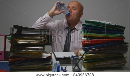 Thirsty Businessman At Work In Accounting Room Drinking Fresh Water