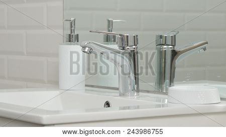 Modern Bathroom Picture With Sink And Faucet With Flowing Water