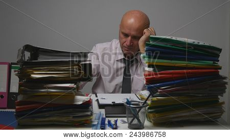 Preoccupied Businessman Reading Financial Paper Documents In Office Room