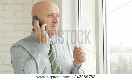 Pleased Businessperson Image Talking To Cell Phone In Office Room