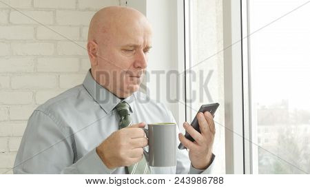 Relaxed Businessman Image In Office Room Text And Drink Coffee