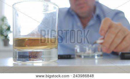 Relaxed Man Drink Alcohol Smoke Cigarette And Use Ashtray