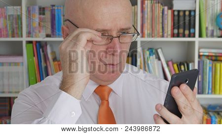 Amazed Businessman Reading Financial News On Cell Phone