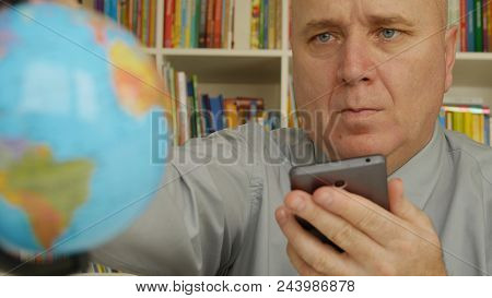 Businessman With Mobile In Hand Looking To World Map