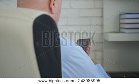 Businessman In Office Room Chair Text Using Mobile Phone