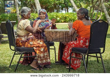 Sri Lanka, Bentota - 14 April 2018: A Group Of Elderly Women In National Costumes Entertains Guests 