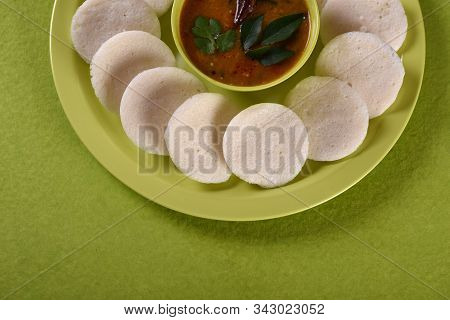 Idli With Sambar In Bowl On Green Background, Indian Dish : South Indian Favourite Food Rava Idli Or
