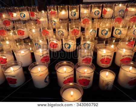 Bayeux, France - May 3, 2019. Votive Candles Saying We Will Remember, For Peace, Lord, Send The Worl