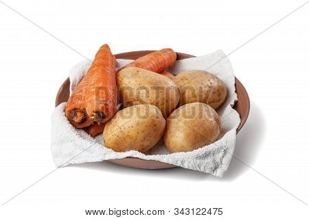 Boiled Potatoes And Carrots On A Towel In A Plate On A White Background