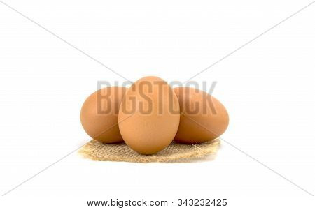 Chicken Egg Isolated On Sack Cloth  And White Background.