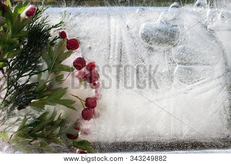 Background Ofed Berry Of Hawthorn And Twif Of Juniper   In Ice   Cube With Air Bubbles. Happy New Ye