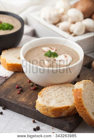 Ceramic Bowl Plates Of Creamy Chestnut Champignon Mushroom Soup With Spoon, Pepper And Kitchen Cloth