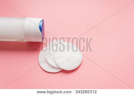Micellar Water With Cotton Pads On A Pastel Pink Background. The Concept Of Cleansing And Moisturizi