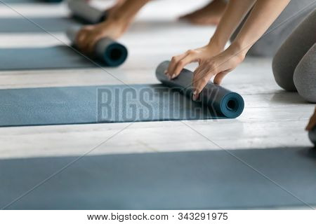 People Folding Yoga Mat After Working Out In Studio