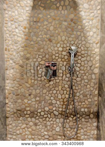 Modern Luxurious Shower Cabin With Shower Head And Stone Rocks Placed As Tiles For Contemporary Natu