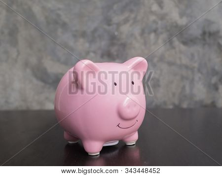 Pink Piggy Bank On Black Cement Wall Background, Saving Money For Future Plan And Retirement Fund Co